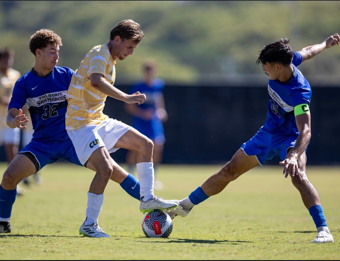 Julian Svoboda battles for the ball against two San Marcos athletes